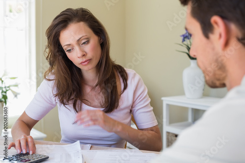 Woman and man sitting with home bills at table