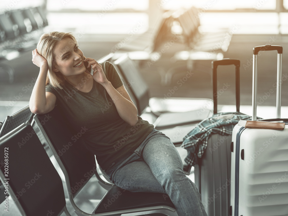 Φωτογραφία Portrait of glad girl telling by phone while sitting on chair in lounge zone