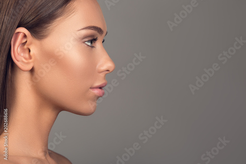 Side view profile of well groomed girl having ideal derma. Copy space in right side. Isolated on background