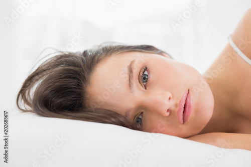 Portrait of a pretty young woman in bed