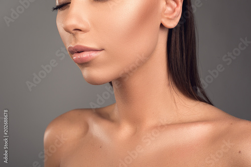 Innocence concept. Young lady having perfect skin. She is closing eyes. Isolated on background