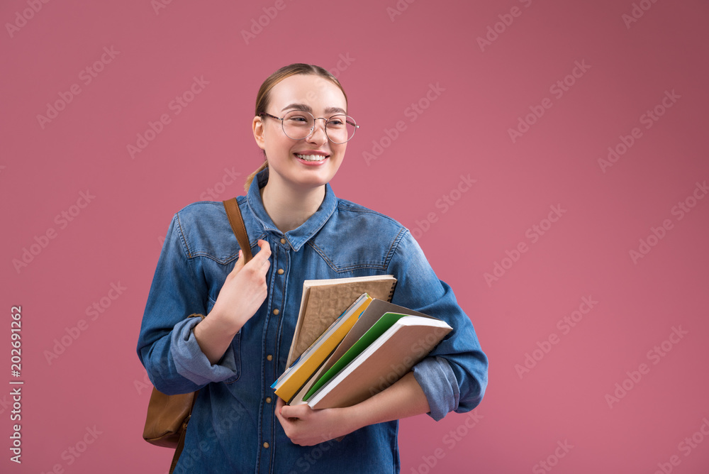 I like studying. Portrait of satisfied female student holding books and laughing. Isolated and copy space I like studying. Portrait of satisfied female student holding books and laughing. Isolated and copy space