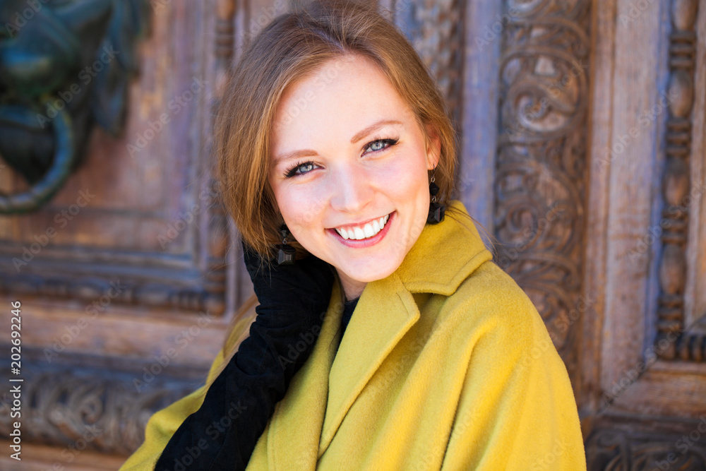 Portrait of a young beautiful woman in yellow coat Portrait of a young beautiful woman in yellow coat
