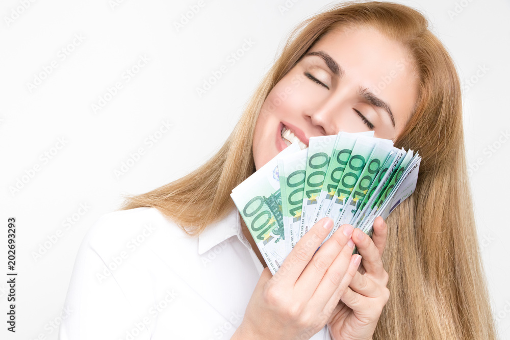 Gorgeous blonde woman holds 100 euro banknotes fanned in her hands Gorgeous blonde woman holds 100 euro banknotes fanned in her hands