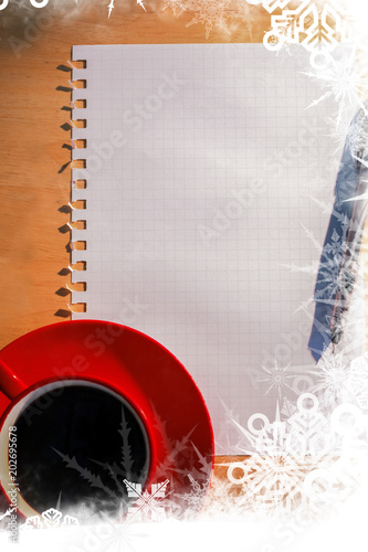 Frost frame over overhead of graph paper coffee and pen