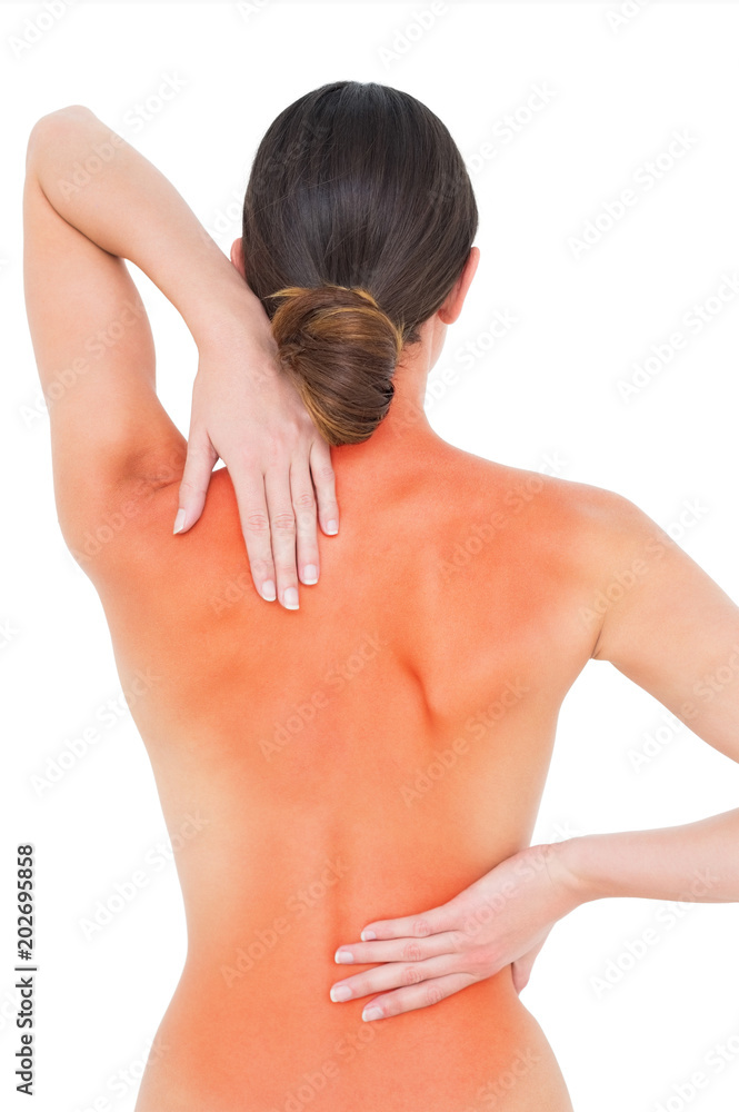 Obraz premium Rear view of a fit topless young woman with back pain standing over white background