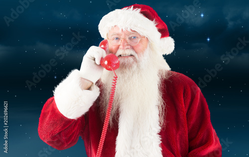 Santa claus on the phone against stars twinkling in night sky