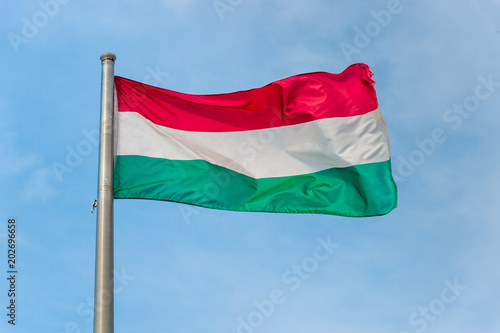 Fototapeta Hungarian national flag over blue sky