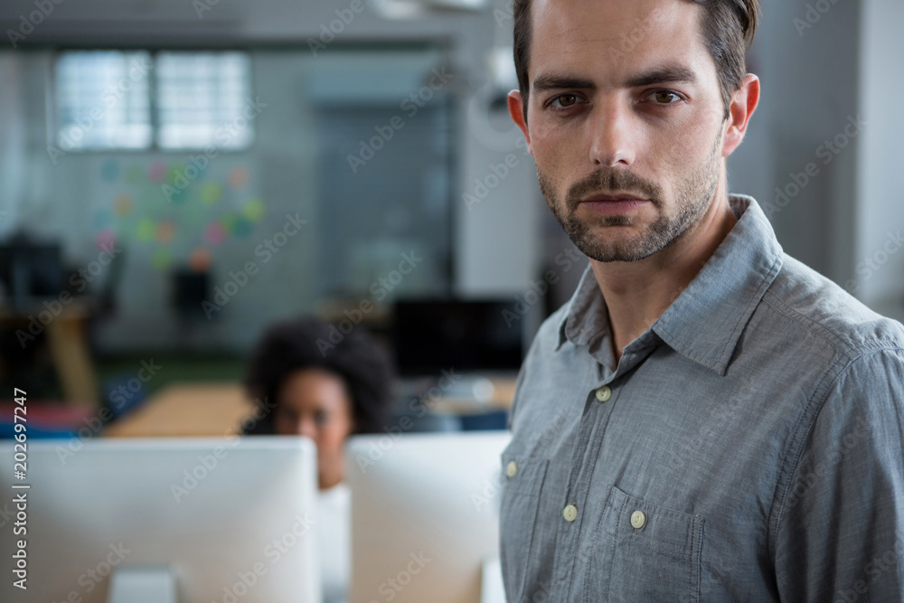 Serious man standing in office Serious man standing in office