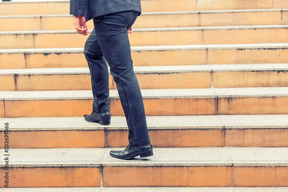 Business man going up the stairs in a rush hour to work. Hurry time. Business man going up the stairs in a rush hour to work. Hurry time.