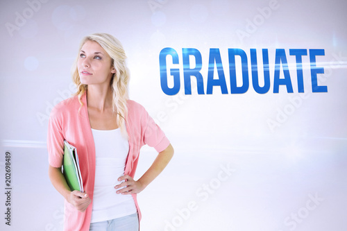 The word graduate and young pretty student smiling against grey background