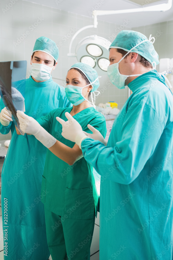 Close up of a surgical team speaking of a Xray Close up of a surgical team speaking of a Xray