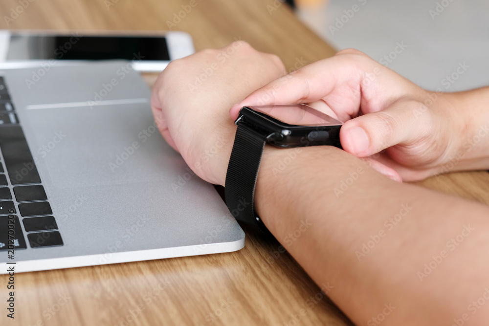 Man hand touching smartwatch, technology lifestyle concept Man hand touching smartwatch, technology lifestyle concept
