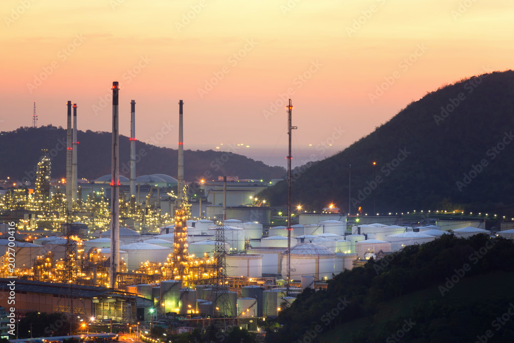Industrial view Oil refinery and oil tanks plant during at twilight.