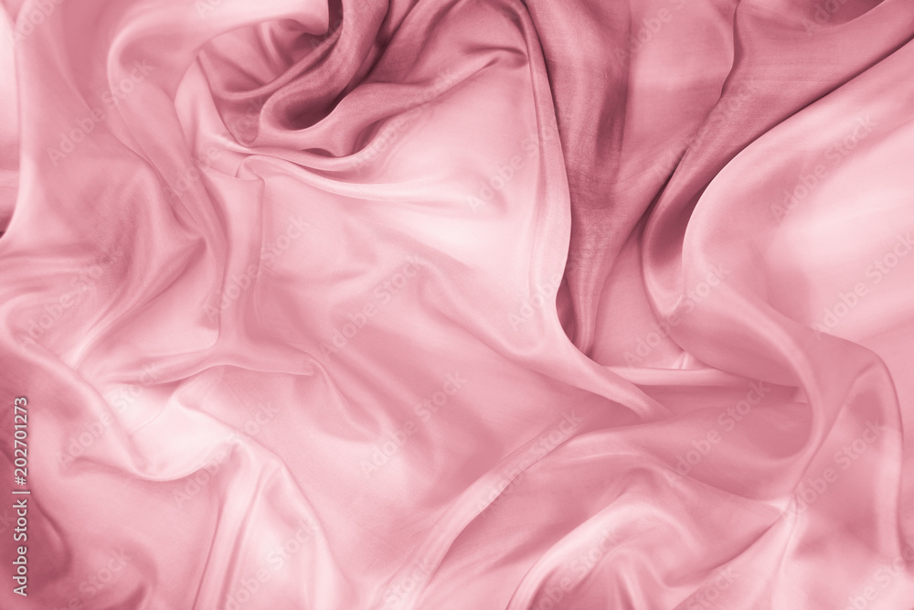 The texture of the satin fabric of pink color for the background The texture of the satin fabric of pink color for the background