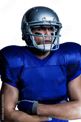 Confident American football player with arms crossed