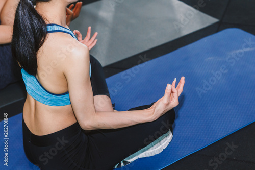 Woman practicing yoga in fitness gym