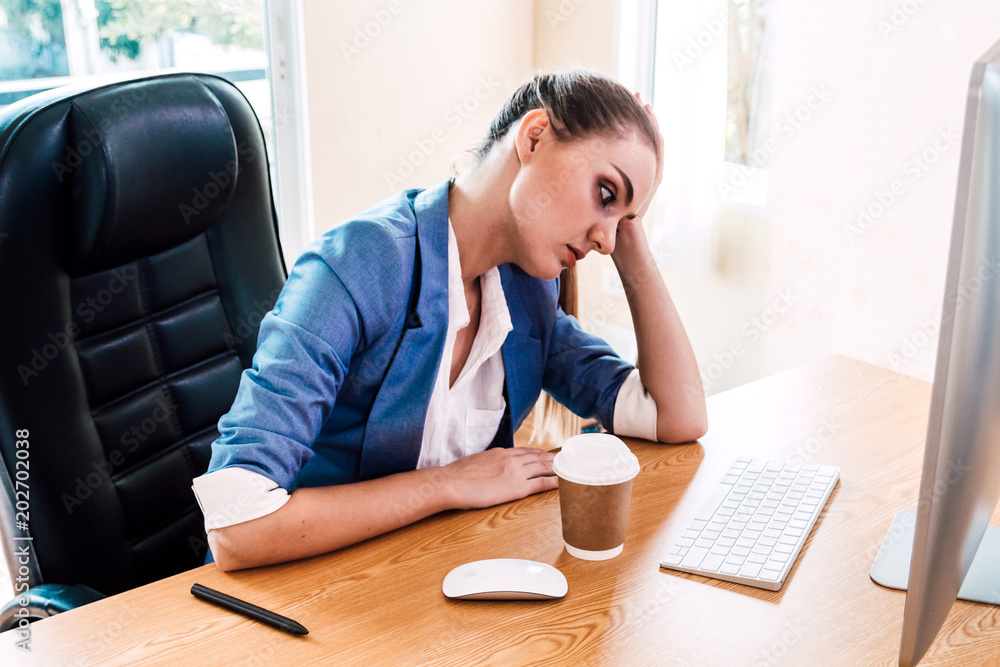 Businesswoman having problems and feeling headache while doing work at workplace, feeling tired exhausted at office Businesswoman having problems and feeling headache while doing work at workplace, feeling tired exhausted at office