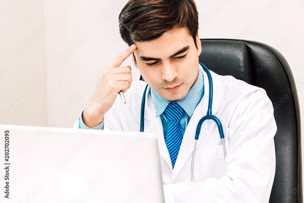 Doctor and stethoscope working with laptop computer in hospital.healthcare and medicine Doctor and stethoscope working with laptop computer in hospital.healthcare and medicine