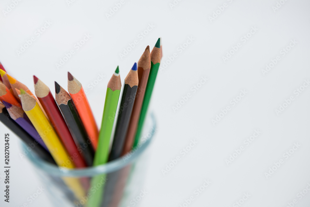 Colored pencils kept in glass on white background Colored pencils kept in glass on white background