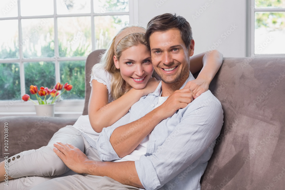 Portrait of relaxed loving couple sitting on sofa Portrait of relaxed loving couple sitting on sofa