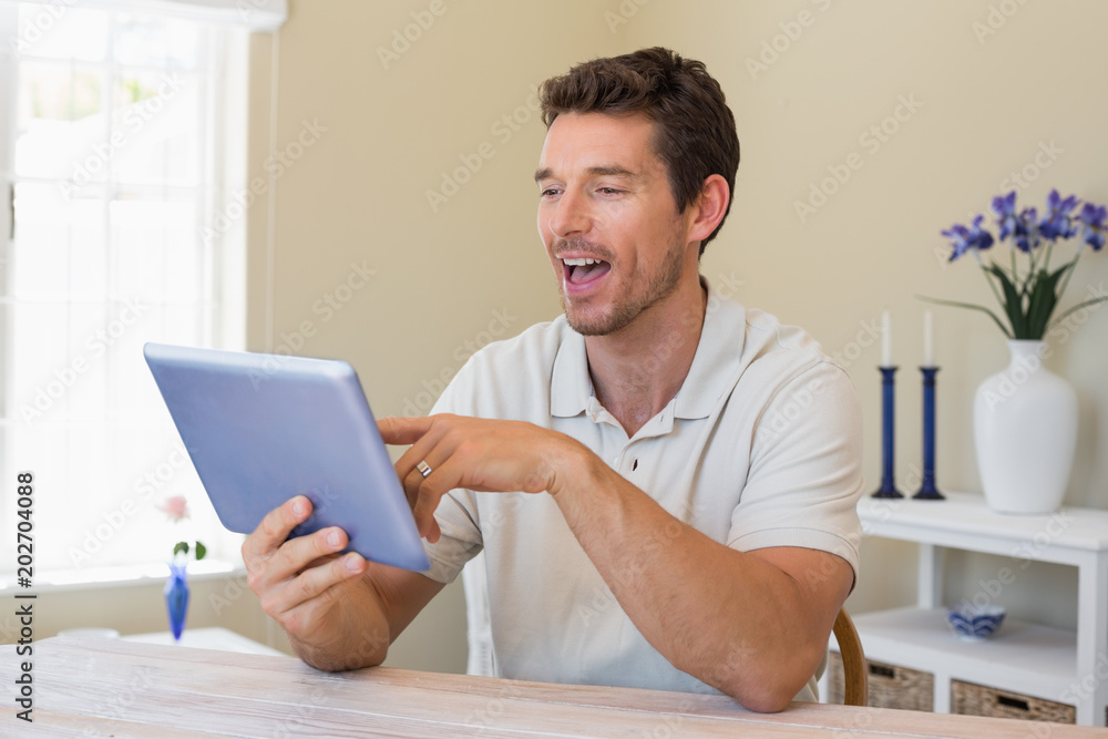 Happy young man using digital tablet Happy young man using digital tablet
