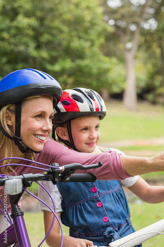 Mother and her daughter on their bike Mother and her daughter on their bike