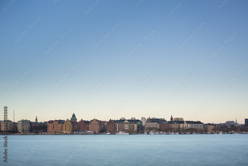 Beautiful scenic panorama of the Old City (Gamla Stan) cityscape pier architecture with historic town houses with colored facade in Stockholm, Sweden. Creative long time exposure landscape photography