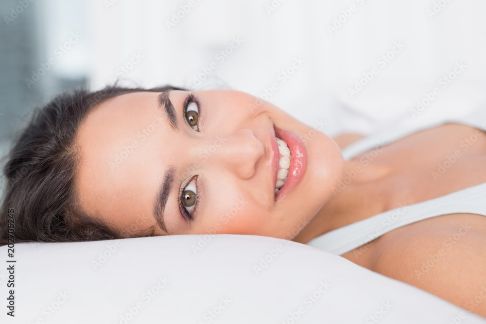 Closeup of a smiling pretty woman lying in bed Closeup of a smiling pretty woman lying in bed