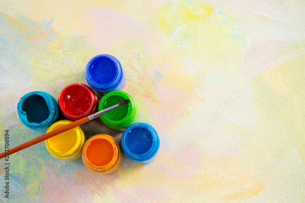 Paintbrush and watercolors arranged on paper Paintbrush and watercolors arranged on paper