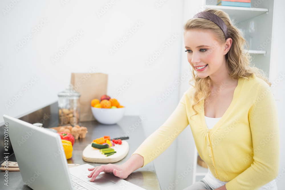 Happy cute blonde using laptop Happy cute blonde using laptop