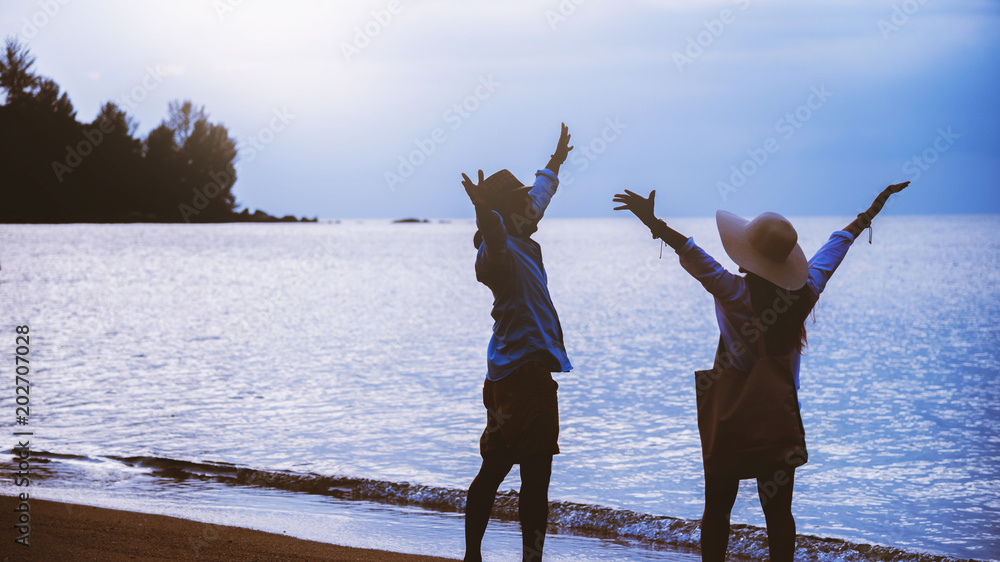 Fototapeta premium Asian lover couple woman and man travel nature. Travel relax. Walking on the beach. In the summer
