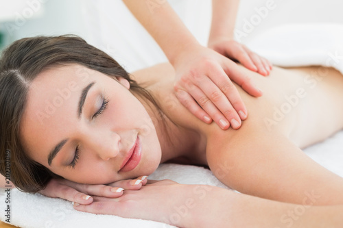 Beautiful woman enjoying back massage at beauty spa