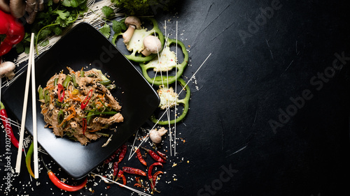 traditional oriental cuisine food preparing craft. rice noodle beef and vegetable on a plate. copyspace concept