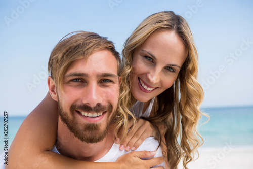 Close up portrait of boyfriend piggybacking girlfriend