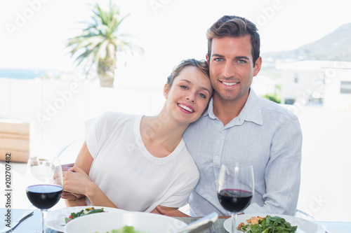 Loving couple with wine glasses at lunch table