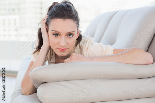 Portrait of a beautiful relaxed casual woman lying on sofa