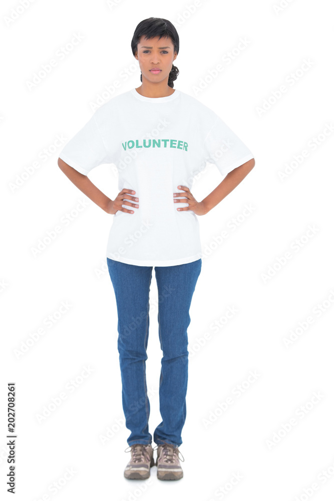 Serious black haired volunteer posing with hands on the hips Serious black haired volunteer posing with hands on the hips