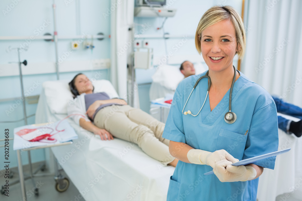 Smiling nurse next to transfused patients Smiling nurse next to transfused patients