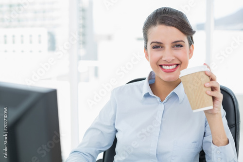 Beautiful classy brown haired businesswoman enjoying coffee