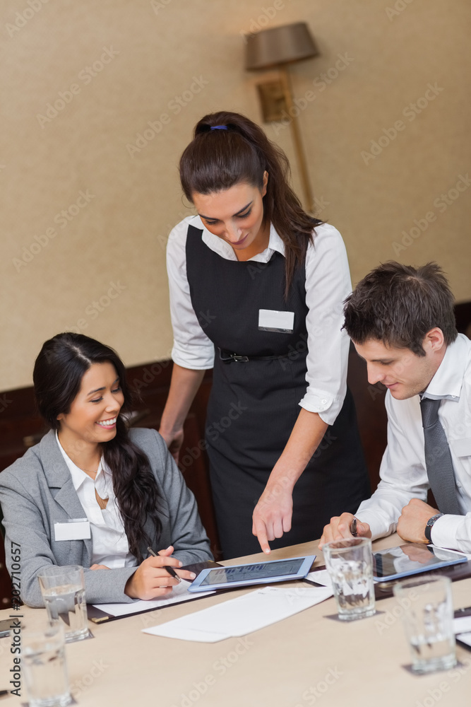 Businesswoman showing something on tablet Businesswoman showing something on tablet