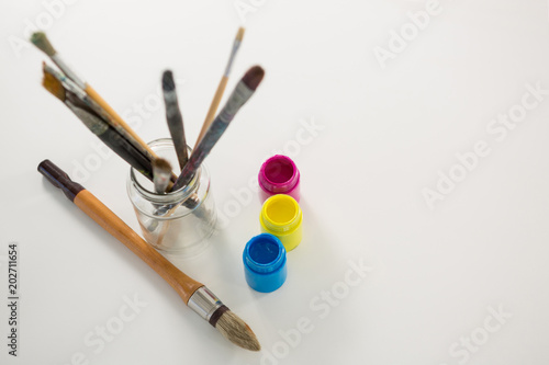 Paintbrushes and watercolor on white background