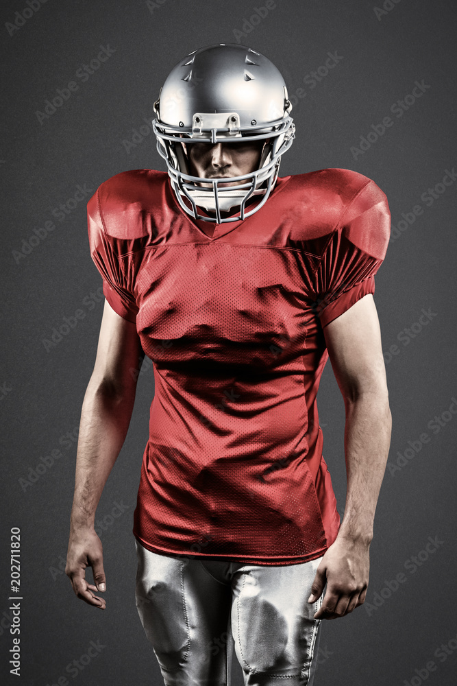 Confident American football player against grey Confident American football player against grey