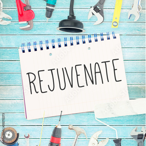 Fotografie The word rejuvenate  against tools and notepad on wooden background