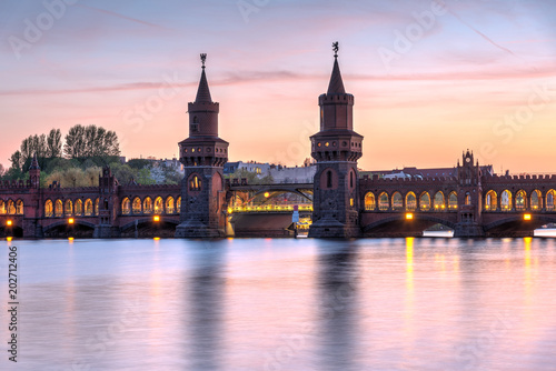 The lovely Oberbaumbruecke across the river Spree in Berlin at sunset © elxeneize