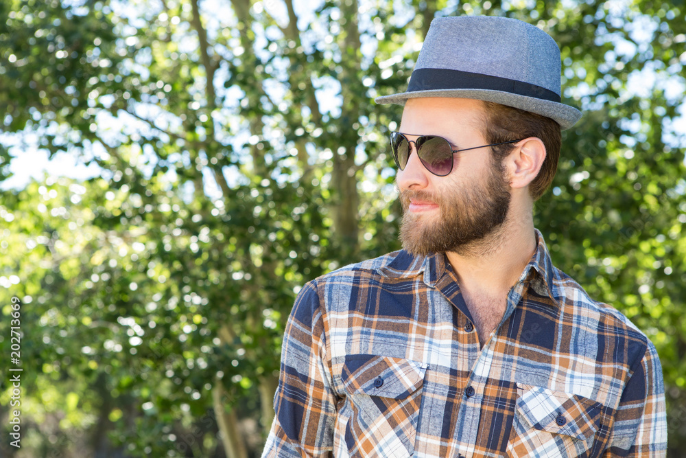 Handsome hipster smiling in the park Handsome hipster smiling in the park