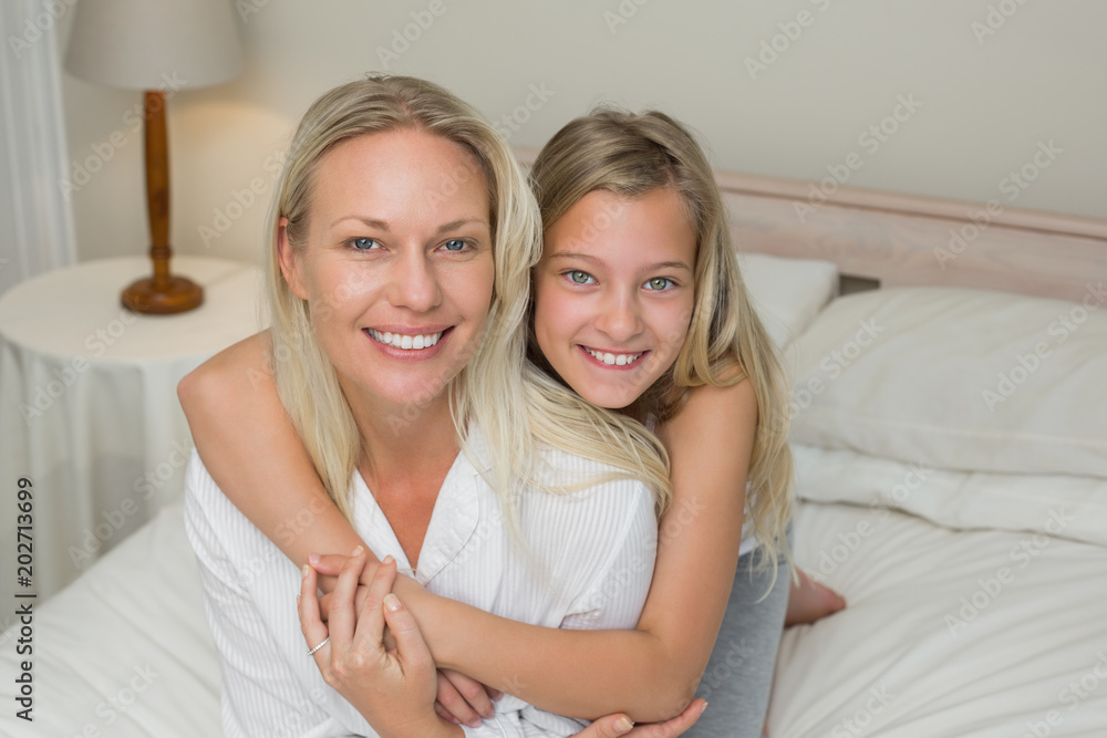Mother and daughter sitting together in bed Mother and daughter sitting together in bed