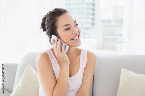 Relaxed happy woman using cellphone on sofa Free Download Relaxed happy woman using cellphone on sofa - GFXLoad