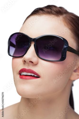 Smiling sensual model wearing classy sunglasses