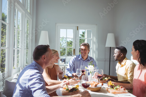 Group of friends interacting while having meal